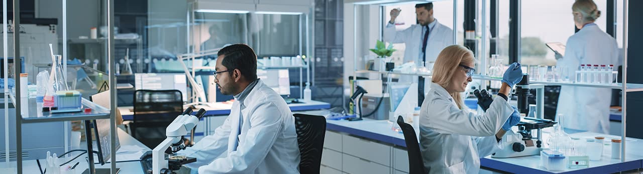 People in white coats working in a laboratory