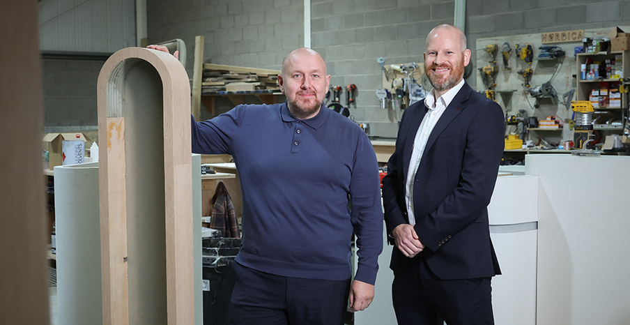 Two men standing in a interior architecture and design warehouse 